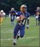  ?? PAUL DICICCO — THE NEWS-HERALD ?? Wickliffe’s Isaac Pettway looks for space Sept. 7 against East Tech. Pettway had seven carries for 131 yards and three touchdowns as the Blue Devils won, 42-0.