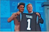  ?? David Eulitt/Getty Images North America/TNS ?? Bryce Young, left, with NFL Commission­er Roger Goodell after being selected first overall by the Carolina Panthers during the first round of the NFL Draft at Union Station in Kansas City, Missouri, on April 27.