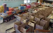  ?? ?? Toys await wrapping and boxes are ready to be packed by Kid Santa volunteers.