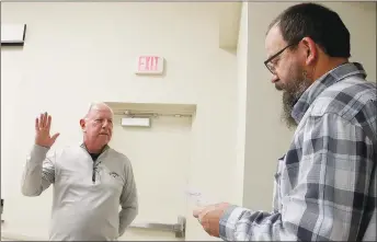  ?? LYNN KUTTER ENTERPRISE-LEADER ?? Lincoln Mayor Doug Hutchens, right, performs the oath of office for David McBride, who was appointed last week to fill the Ward 4, Position 1 vacancy on the Lincoln City Council. McBride is retired as pastor of The Sanctuary in Lincoln.