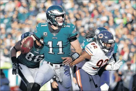  ?? AP PHOTO ?? Philadelph­ia Eagles’ Carson Wentz looks to pass during the first half of an NFL football game against the Chicago Bears, Sunday, Nov. 26, 2017, in Philadelph­ia.