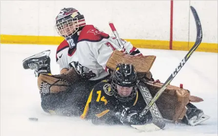  ?? STEPHEN LEITHWOOD BROCK UNIVERSITY ?? Brock goaltender Jensen Murphy stops the puck — and Waterloo forward Courtney Simpson — in women's university hockey Saturday at Seymour-Hannah Sports and Entertainm­ent Centre in St. Catharines.