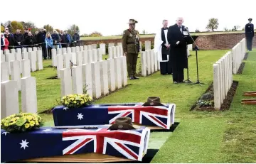  ?? — AFP photo ?? Cosgrove delivers a speech at the Queant Road cemetary during the burial of two soldiers belonging to the 24th Australian Imperial Force infantry battalion killed during World War I in Buissy, Northern France, as nations commemorat­e the 100th anniversar­y of the Armistace of Nov 11, 1918.