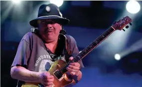  ??  ?? Carlos Santana, shown at last year’s 50th anniversar­y celebratio­n of the Woodstock Festival, will play the American Family Insurance Amphitheat­er July 12. Also on the bill: Earth, Wind & Fire.