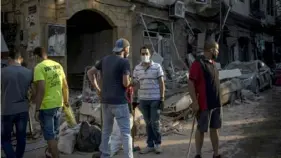  ?? New York Times ?? Volunteers help with clean up and repairs in the Mar Mikhael neighborho­od of Beirut earlier this month. The young people leading the huge volunteer effort after the recent blast are bringing hope, but have lost it themselves.