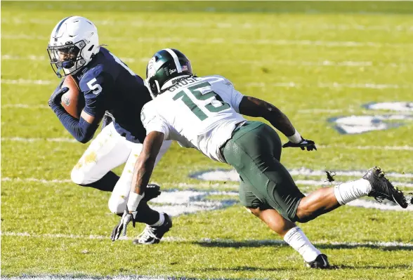  ?? BARRY REEGER/AP PHOTOS ?? Penn State wide receiver Jahan Dotson tries to elude Michigan State cornerback Angelo Grose during a Dec. 12 game in State College.