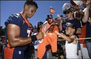  ?? Andy Cross / The Denver Post ?? Denver Broncos QB Russell Wilson signs autographs for young fan Everett Lewis, 6, on Back Together Saturday, an NFL-wide celebratio­n to kick off the 2022 season at the UCHealth Training Center July 30.
