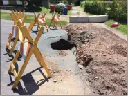  ?? EVAN BRANDT — MEDIANEWS GROUP ?? A new sinkhole in Pottstown’s aging stormwater tunnels, this one off Airy Street between Spruce and North Hanover streets, opened up as a result of the erosive power of the water rushing through it Thursday.