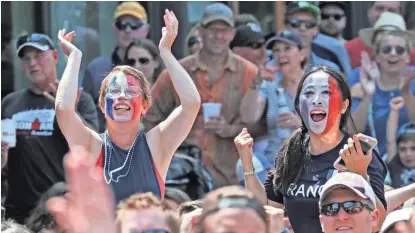  ?? MICHAEL SEARS / MILWAUKEE JOURNAL SENTINEL ?? Anne Pycha (left) and Shoko Izumi, both of Shorewood, celebrate France's fourth goal. Pycha said she will be leaving shortly to spend a year in France.