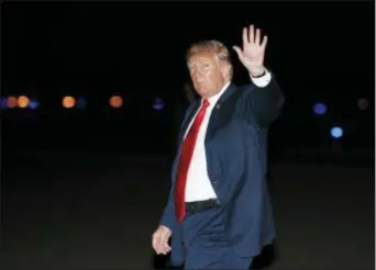  ?? CAROLYN KASTER — THE ASSOCIATED PRESS ?? President Donald Trump waves as he arrives on Air Force One at Morristown Municipal Airport, in Morristown, N.J., Saturday en route to Trump National Golf Club in Bedminster, N.J., after attending a rally in Lewis Center, Ohio.