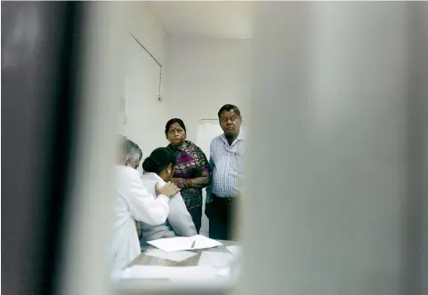  ??  ?? GLIMPSE OF THE FUTURE: A couple with their daughter who suffers from pulmonary infection at hospital in New Delhi. Our photograph­er saw patients struggling to breathe.