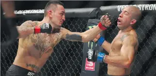  ?? GREGORY SHAMUS/GETTY IMAGES ?? Max Holloway, left, battles Jose Aldo during UFC 218 at Little Caesars Arena on Saturday in Detroit. Aldo will go into the UFC Hall of Fame and will always be a legend in Brazil.