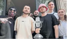  ?? LUCA BRUNO THE ASSOCIATED PRESS ?? Ukraine’s Kalush Orchestra pose with their trophy after winning the the Eurovision Song Contest, in Turin, Italy.