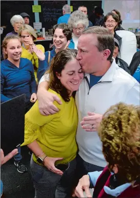  ?? PETER HUOPPI/THE DAY ?? Rep. Christine Conley, left, celebrates with her husband Timothy Beebe as results are posted at Groton Democratic headquarte­rs on Tuesday.