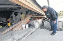  ??  ?? Skip Muise, an owner of Wedgeport Boat Ltd., surveys the destructio­n of a mould shop at the Yarmouth County property following Dorian.