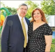  ??  ?? Tom Caramanico of Haverford and Mary Beth Driscoll of Jenkintown take in the fountains and flowers adorning the park.