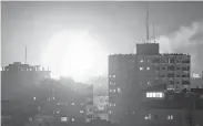  ?? Mahmud Hams / AFP / Getty Images ?? A ball of fire rises above the building housing the Hamas-run television station Al-Aqsa in the Gaza Strip during an Israeli airstrike on Monday.