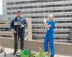  ??  ?? Dr. Anastasios Kapetanos, director of Allegheny Health Network Internal Medicine Residency Program, left, and Dr. Deanna Huffman prepare to work in the residency garden.