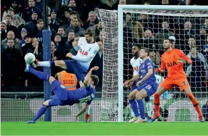  ?? Reuters ?? Tottenham’s Fernando Llorente vies for the ball with Chelsea’s Olivier Giroud during the Carabao Cup semifinal first leg. —