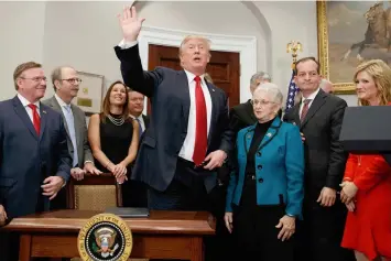  ?? (AP) ?? President Donald Trump waves after signing an executive order on health care in the Roosevelt Room of the White House, Thursday, Oct. 12, in Washington.