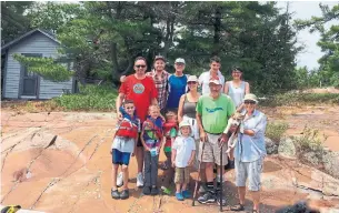  ?? COURTESY JANE LEE/THE CANADIAN PRESS ?? Jane Lee, right, and her family at their cottage on Humbum Island in Key River. A raging blaze known as Parry Sound 33 burned their cabins and a lighthouse on the island to the ground.