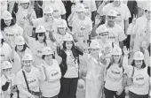  ?? MARK LENNIHAN, AP ?? Nia Sanchez, former Miss USA, joins hundreds of volunteers in pink hard hats and shirts in New York to mark Breast Cancer Awareness Month in October 2014.