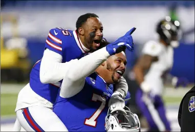  ?? JOHN MUNSON — THE ASSOCIATED PRESS ?? The Bills’ Taiwan Jones (25) celebrates with Dion Dawkins (73) after beating the Ravens on Jan. 16.