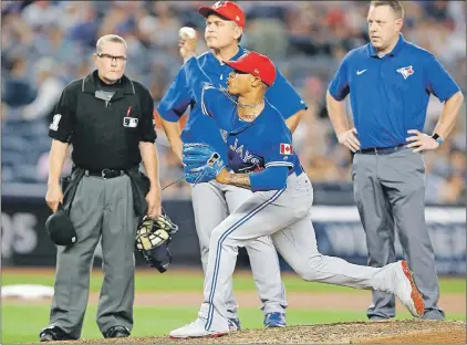  ?? Ap Photo ?? From left, home plate umpire Jerry Meals, Toronto Blue Jays manager John Gibbons and Blue Jays trainer, Mike Frostad, right, watch as Toronto Blue Jays starting pitcher Marcus Stroman throws under supervisio­n during the fifth inning of a game against...