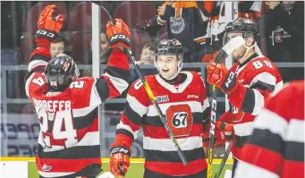  ?? VALERIE WUTTI/OTTAWA 67'S ?? Cameron Tolnai, centre, celebrates an overtime goal against Barrie with teammates Joseph Garreffa, left, and Kevin Bahl in February 2020. Then, he was a relative youngster. Now, after a missed OHL season owing to the pandemic, he'll be counted on to be a front-line leader.