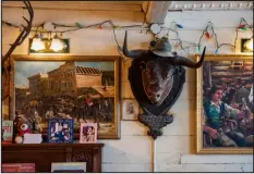  ?? ?? Eclectic wall decor in a tavern known as The Pit inside the Westminste­r Hotel, in the Yukon town of Dawson City, Canada, on Jan. 26.