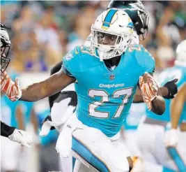  ?? WINSLOW TOWNSON/AP ?? Former Miami Hurricane and present Miami Dolphin, running back Storm Johnson, is one of the many players whose immediate future in the NFL will be decided tonight and this weekend.