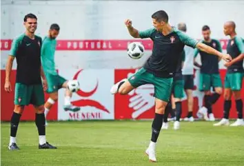  ?? Reuters ?? Cristiano Ronaldo tries a trick as Pepe watches during a training session at Kratovo. Portugal have two victories from as many matches in the Group B.