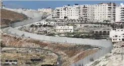  ??  ?? This photo taken on Feb 6, 2017 shows Israel’s separation barrier dividing east Jerusalem (left) from the West Bank village of Anata. — AFP photos