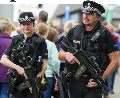  ??  ?? Equal partnershi­p: Two armed police officers on patrol at the Royal Highland Show