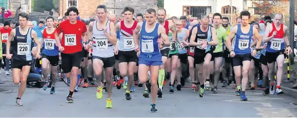  ??  ?? Off and running as local boy Matt Clowes, centre, leads from the front at the annual Cheddleton Christmas Pudding race. Pictures: Bryan Dale