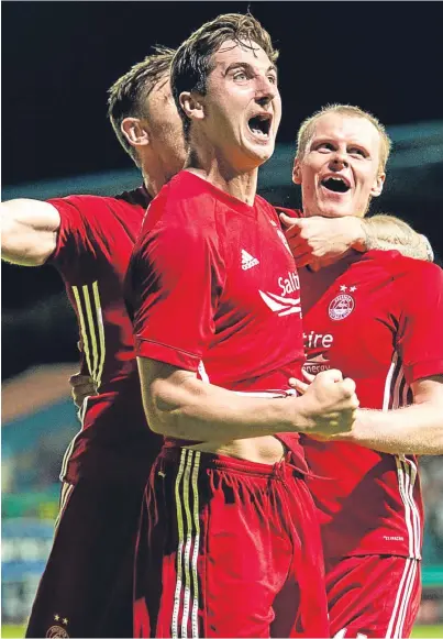  ??  ?? MAIN MAN: Dons midfielder Kenny McLean, centre, has become a prized Pittodrie asset