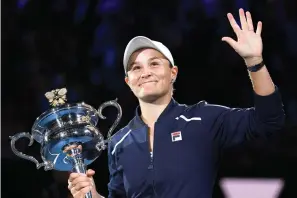  ?? AP Photo/Andy Brownbill ?? ■ Ash Barty of Australia waves Saturday as she holds the Daphne Akhurst Memorial Cup after defeating Danielle Collins of the U.S., in the women’s singles final at the Australian Open tennis championsh­ips in Melbourne, Australia.