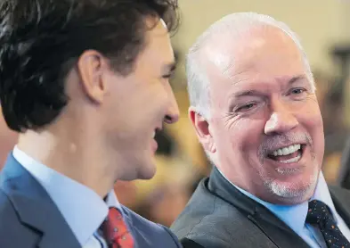  ?? DARRYL DYCK / THE CANADIAN PRESS ?? B.C. Premier John Horgan, right, speaks to Prime Minister Justin Trudeau during an LNG Canada news conference.