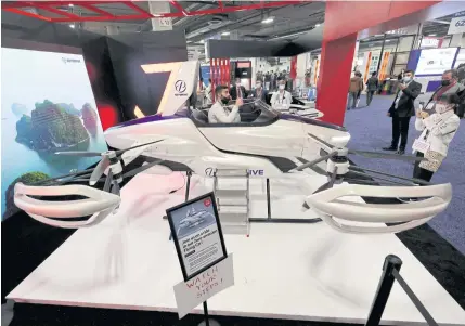  ?? GETTY IMAGES/AFP ?? An attendee takes a selfie inside a SkyDrive SD-03 compact flying vehicle on display at CES 2022 in Las Vegas on Wednesday.