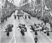  ?? LEONARD BARTHOLOME­W/CHICAGO TRIBUNE ?? Pompom girls from Lyons Township High School in La Grange perform in the Christmas Parade in November 1963 at State and Van Buren streets. Supporting jolly old Santa’s star billing were nearly 3,000 participan­ts.