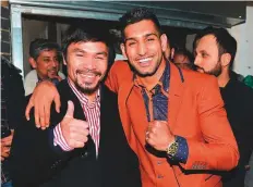  ?? Rex Features ?? Manny Pacquiao and Amir Khan in London. The two boxing superstars could go head to head in December.