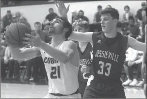  ?? The Sentinel-Record/Richard Rasmussen ?? REVERSE: Fountain Lake’s Joe Murphy (21) attempts a reverse shot Tuesday against Jesse Bearden (33) in the Lions’ 53-48 win. Both teams are scheduled for games on Friday.