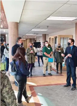  ?? ?? Marcos Maez (far right), LSF Class of 2018 alumni and Director of Student Recruitmen­t, leads a tour of Santa Fe Community College.