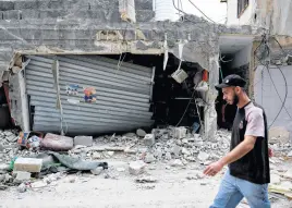  ?? AMMAR AWAD • REUTERS ?? A Palestinia­n man passes by rubble on April 21 following an Israeli raid at Nur Shams camp in Tulkarm, in the Israeli-occupied West Bank.