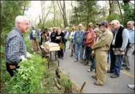  ?? Democrat-Gazette file photo/ANDY SHUPE ?? The University of Arkansas Cooperativ­e Extension Service sponsors a vast range of horticultu­re programs, including efforts like this 2011 workshop on removing invasive plants in Fayettevil­le given by entomologi­st Don Steinkraus.