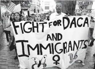  ?? AFP PHOTO ?? MARCH FOR DREAMERS
Nevada Senate Majority Leader Aaron D. Ford (D-Las Vegas) (3rd L) joins immigrants and supporters as they march on the Las Vegas Strip during a “We Rise for the Dream” rally to oppose US President Donald Trump’s order to end DACA on...