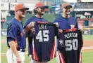  ?? Karen Warren / Houston Chronicle ?? A.J. Hinch gives Gerrit Cole (45) and Charlie Morton their All-Star jerseys.