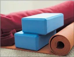  ?? — FOTOLIA FILES ?? Many yoga studios will let you borrow a yoga mat or foam blocks to assist you with certain poses during the class but it is probably a good idea to bring your own.