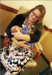  ??  ?? Peer breastfeed­ing counselor Hia Weitzman, a mother of three, demonstrat­ing with a doll at the new Baby Café in Troy.