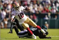  ??  ?? San Francisco 49ers quarterbac­k Jimmy Garoppolo (10) is stopped by Philadelph­ia Eagles linebacker Genard Avery (58) during the second half Sunday in Philadelph­ia.